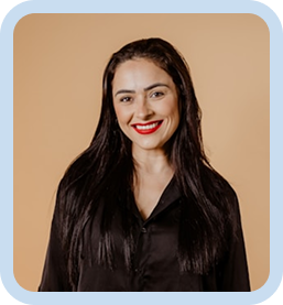 Smiling woman with long dark hair wearing a black blouse against a tan background