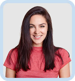 Smiling young woman with long dark hair wearing a red shirt against a light background