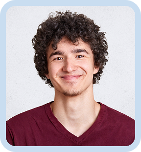 Smiling young man with curly hair wearing a maroon shirt against a light background