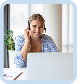 Smiling woman wearing a headset while talking with a client during a virtual meeting
